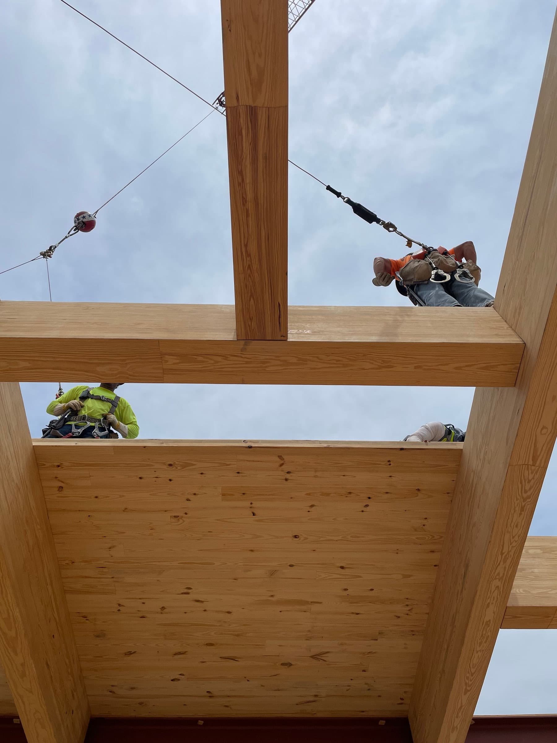 Ironworkers on mass timber beams